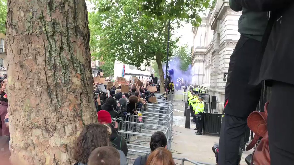 Scene at the Black lives matter George Floyd protest outside Downing Street in London , bottles are being thrown at the police. Video : rachaelvenables